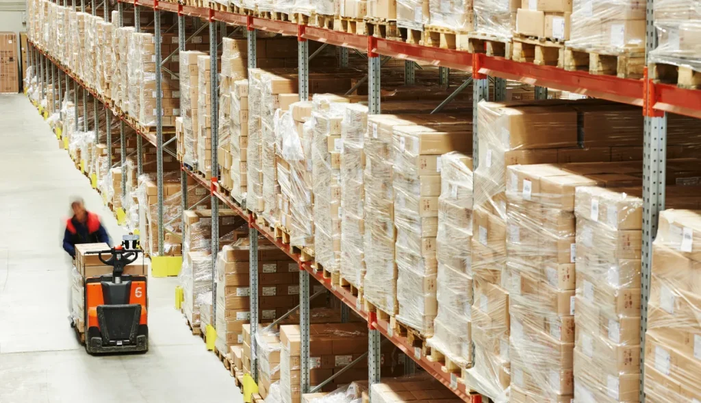 RFID LED tags lighting up to locate inventory items in a large retail warehouse for improved asset tracking.