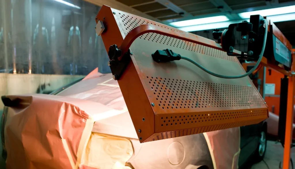 Industrial heating equipment positioned over a covered vehicle, representing hot-environment installation scenarios.