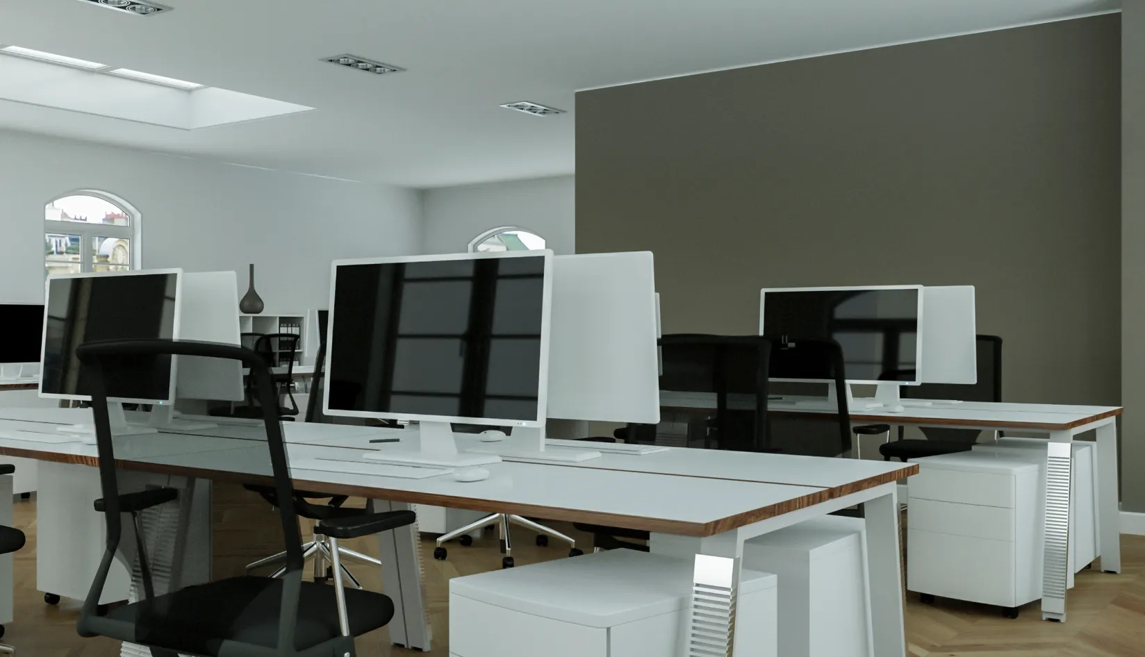 Why Adhesive RFID Asset Tags Are Ideal for Indoor Asset Tracking Bright modern open office workspace with rows of white office desks, monitors and office chairs, indoor asset tracking environment for adhesive RFID asset tags.
